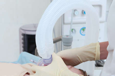 The child is under anesthesia. A mask with oxygen on the childs face. Surgery under general anesthesia. Saving a childs life.の写真素材