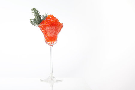 Caviar, a glass wine glass filled with red caviar. White background. Salmon caviar. Delicacies. Delicious food. Concept of delicious food. Space for text.Spruce branch.の写真素材
