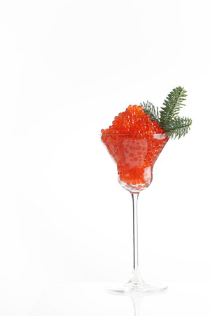 Caviar, a glass wine glass filled with red caviar. White background. Salmon caviar. Delicacies. Delicious food. Concept of delicious food. Space for text.の写真素材