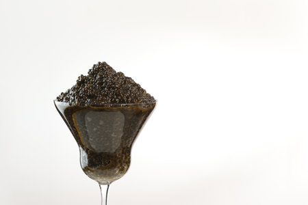 Black caviar in a glass wine glass. Close-up. Salmon caviar. Delicacies. Delicious food. The concept of a luxurious life. A useful omega. An expensive snack.Space for text. White background.の写真素材