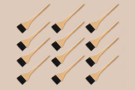 A pattern of brushes with a wooden handle. Hair coloring brushes with a wooden handle.Professional brush for applying paint in the beauty industry.の写真素材