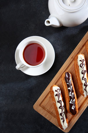 Eclairs with tea.Breakfast concept. Flat lay.Top view.の写真素材