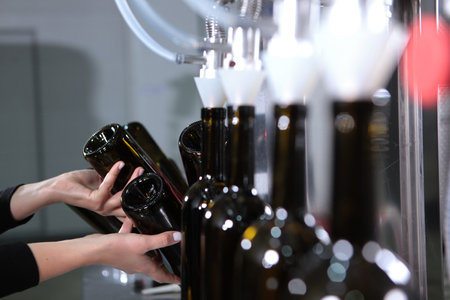 The wine is bottled. A small winery. Empty wine bottles. Craft winery. Authors wine. The concept of a small wine production.New wine harvest.の写真素材