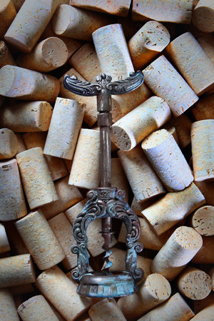 An antique corkscrew.Wine corks. Natural cork. The concept of winemaking.Flat lay.Top view.の写真素材
