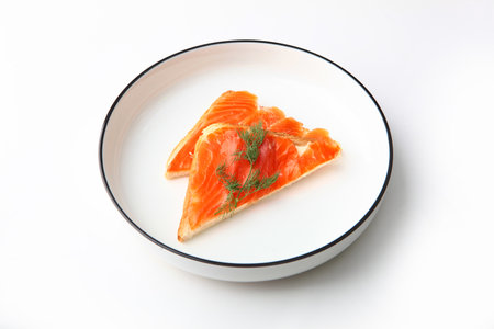 Open sandwiches with red fish. Breakfast concept. A white plate. Photo on a white background. Healthy food. A useful omega. Copy space.Isolated object.の写真素材