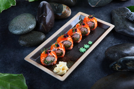 Rolls California with crab.Traditional Japanese cuisine. Rolls with shrimps, tobiko caviar and cucumber. Healthy food. Out of focus. Photo on black background with smoke.の写真素材