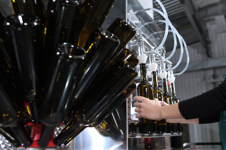 Wine is poured into bottles. New wine. Small wine production. Craft winery.