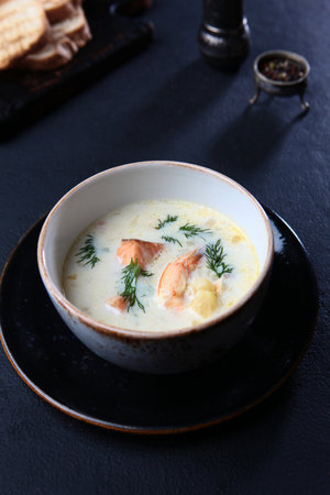 Shrimp and redfish in a traditional French soup.Soup with seafood and cream. Vertical photo.の写真素材
