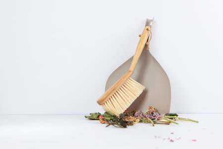 Garbage collection at home. Dustpan and dust brush. House cleaning. Tools for cleaning the house. Garbage is collected in pile. Photo on a white background. Isolated object.Copy space.の写真素材