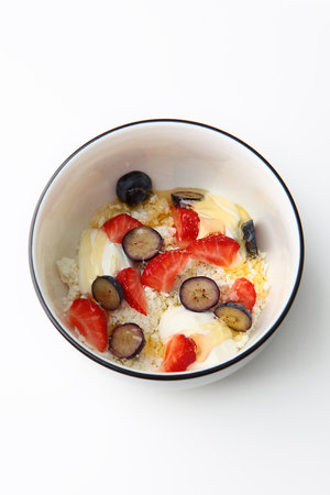 Cottage cheese with strawberries and blueberries, fresh berries. Healthy breakfast concept, top view.Space for copying.Isolated object. Vertical photo.の写真素材