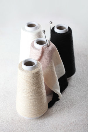 Hobby - knitting. Yarn of warm tones. Pink, peach, beige, white and black.Beginning of knitting...