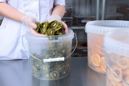 Organic homemade kiwi chips. Dried fruits from kiwi. Production of dried fruits. Dried kiwi. A...