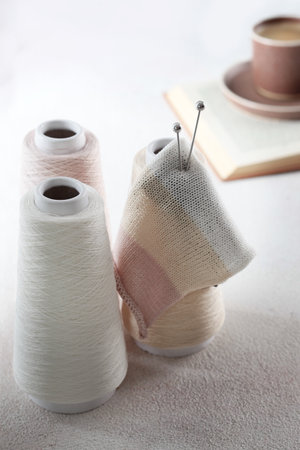 Bobbins with yarn. Cotton yarn on bobbins. Knitting pattern. Balls of yarn. Metal knitting needles. Concept of hobby.の写真素材