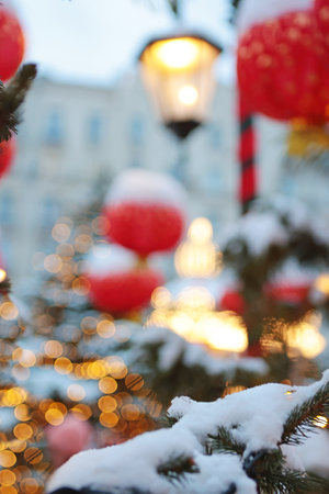 Chinese New Year. Red Chinese lanterns and snow are out of focus. Background for New Years card. Out of focus. Vertical photo.の写真素材