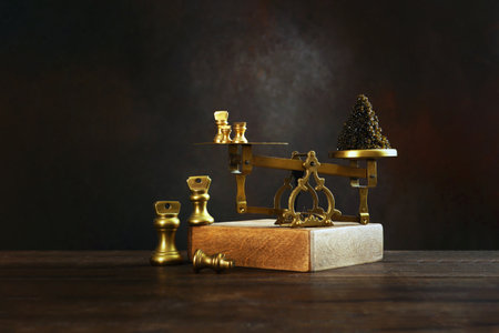 Black caviar. Black caviar is on scales. Caviar is weighed on vintage scales. Delicacy of sturgeon fish. Symbol of wealth and luxurious life. Healthy and natural omega. Copy space.の写真素材