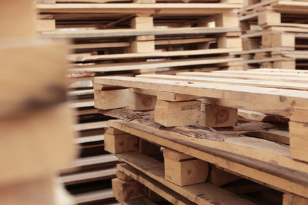 Piles of wooden boards in sawmill. Warehouse for sawing boards on sawmill outdoors. Wood timber...