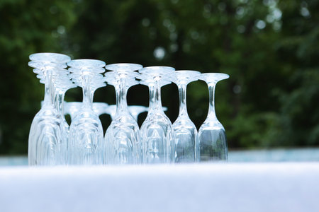 Empty, clean glasses are turned upside down. Glasses are on table. Buffet. Buffet table. Preparation for holiday. Concept of party.の写真素材
