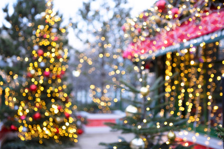 Christmas trees are decorated with garlands. The trees are out of focus. Garland with lights on the Christmas tree. Bokeh.の写真素材