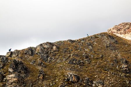 Lonely tourists climb Switzerland mountains in national parkの写真素材