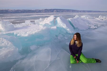 Girl lying on ice of Baikal lakeの写真素材
