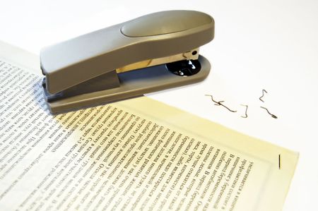 stapler and broken staples on paperの写真素材