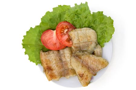 Fish grilled, two slices of red tomatoes, lettuce on a plate isolated on a white backgroundの写真素材