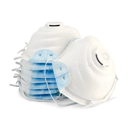 A stack of white with blue detail disposable respirators isolated on white backgroundの写真素材