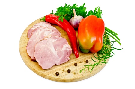 Slices of smoked pork, red pepper, sweet pepper, garlic, parsley, tarragon on a circular wooden board isolated on white backgroundの写真素材