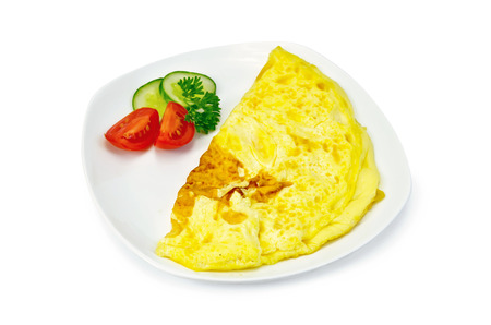 Omelette with slices of tomato, cucumber, parsley on the plate isolated on white backgroundの写真素材