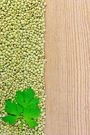 Lentils green on board on the left with parsleyの写真素材