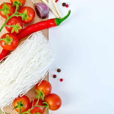 Frame of funchoza and tomatoes with paper on sackingの写真素材