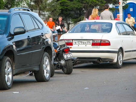 Krasnoyarsk, Russia - February 10, 2019: A motorcycle with an FBI number on the street between two cars.のeditorial素材