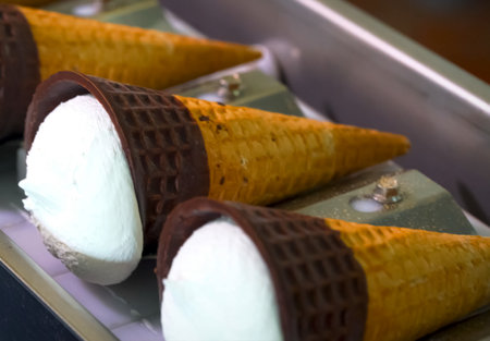 Ice cream cones on a conveyor. Ice cream factory.