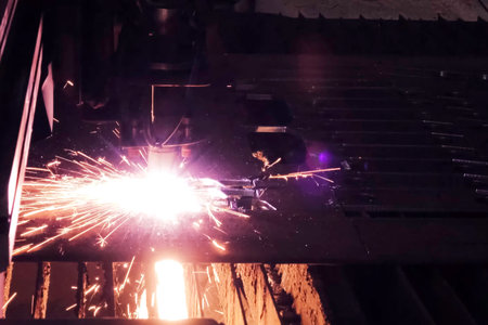 A welder in a mask welds the channel. Welding
