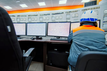 The control panel operator sits at the control panel and works.の写真素材