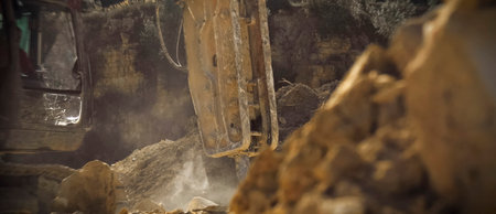 Panorama, the work of a hydraulic hammer on the rock in the quarry.