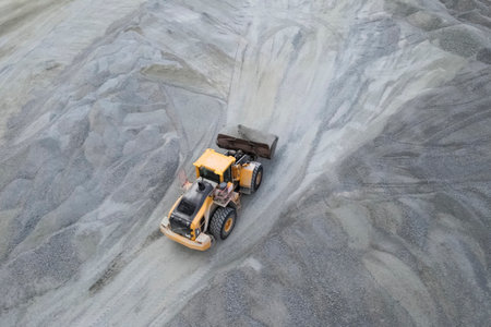 Work of a bulldozer in a quarry for the extraction of migmatites