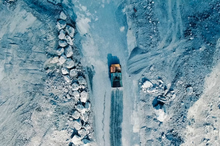 The sprinkler pours water on the road in the quarry,の写真素材