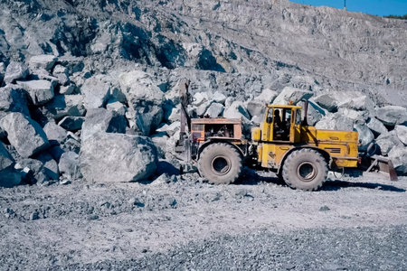 K-700 Kirovets tractor with an attached scraper and hydraulic hammer