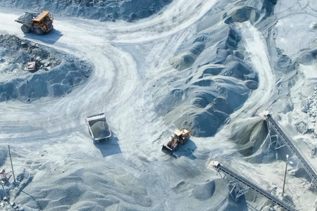 A top-down view of mining trucks driving along the road insideの写真素材