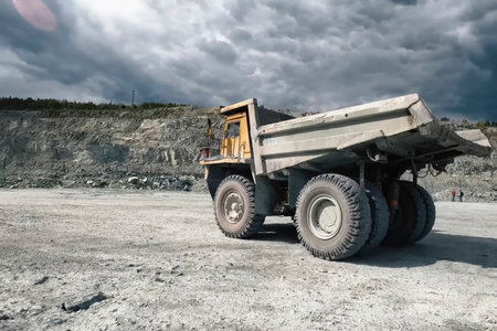 A mining dump truck against the background of a quarry and a sky