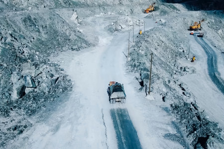 The sprinkler pours water on the road in the quarry,の写真素材
