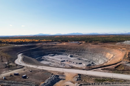 An active gold mining quarry with industrial equipment