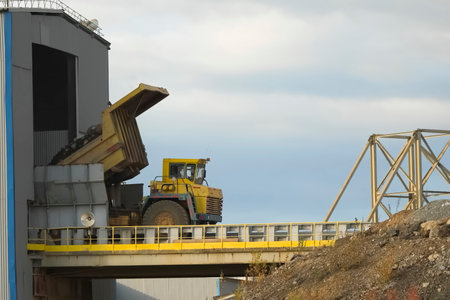 The dump truck unloads ore for receiving for grinding.の写真素材