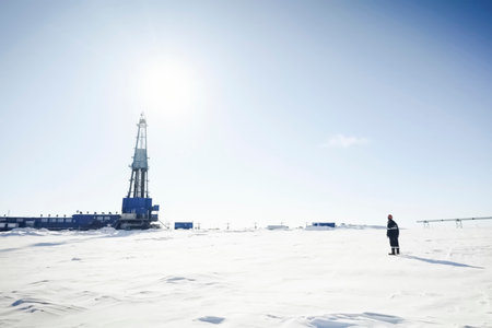 Drilling foreman looking at the drilling rig while standing in the short distanceの写真素材