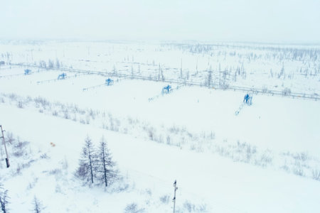 Gas production wells in the snowy tundra, a cluster of wells.の写真素材