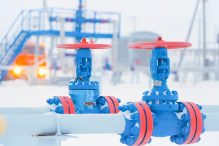 shut-off valves on an oil and gas pipeline, painted blue and red.の写真素材