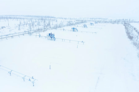 Gas production wells in the snowy tundra, a cluster of wells.
