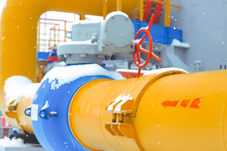 a ball gate valve on the pipeline and an arrow on the pipe showing the direction of gas movement