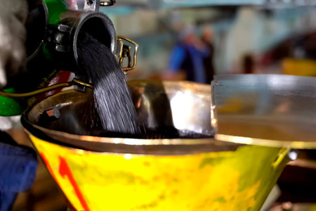 Pouring gunpowder into a receiving container, components for cartridge production.の写真素材